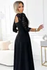 A woman wearing a black dress in a room. Anteprima dell’immagine prodotto