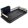 A black dish drying rack with a utensil holder and wooden handles, isolated on a white background. Podgląd zdjęcia produktu
