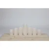 A set of seven LED candles of varying heights arranged on a wooden plank against a plain background. Produktbild-Vorschau