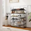 A shoe rack filled with various types of shoes and two umbrellas in a stand next to it, placed in a hallway or entry way. Produktbild-Vorschau