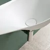 A close-up view of a modern white sink with a silver drain and drain cover, set against a green and light gray textured background. Produktbild-Vorschau