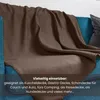 A brown fleece blanket draped over a blue sofa. Produktbild-Vorschau