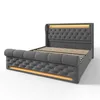 A gray upholstered bed with LED lighting. Produktbild-Vorschau