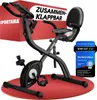 A black foldable exercise bike is shown on a red mat, with a red box in the background featuring text. Produktbild-Vorschau