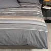 A close-up view of a striped duvet cover on a bed. Produktbild-Vorschau