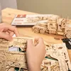 Hands assembling a wooden model truck. Náhľad obrázku produktu