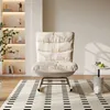 A modern living room with a beige rocking chair, a small side table with a marble base, and a striped rug. Náhľad obrázku produktu