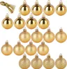 A collection of gold-colored Christmas ornaments arranged in rows. Voir les images du produit
