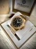 A gold Versace watch with a black face is displayed in its packaging. Produktbild-Vorschau