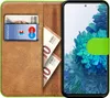 A wallet-style phone case with a Samsung Galaxy S20 FE phone inside, showing cards and banknotes. Produktbild-Vorschau