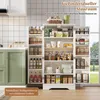 A white kitchen cabinet with green doors is shown next to a tall white pantry cabinet filled with various food items and kitchenware. Voir les images du produit