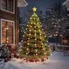 A decorated Christmas tree with lights and ornaments stands in the snow next to a wooden house. Náhled obrázku produktu