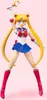 A full-body shot of a Sailor Moon action figure against a pink background. Produktbild-Vorschau