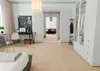 A bedroom with a desk, chair, and wardrobe, showing the vinyl planks on the floor. Produktbild-Vorschau