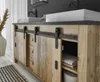 A bathroom vanity with sliding barn doors, two sinks, and faucets. Produktbild-Vorschau