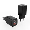 Two black USB chargers are displayed on a white background. One charger is in the foreground, angled with its USB port facing the viewer. The other charger is in the background, standing upright. Produktbild-Vorschau