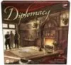 The image shows the box art for the board game Diplomacy, depicting a scene inside a richly decorated room with a fireplace and several figures. Produktbild-Vorschau