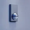 A motion detector mounted on a wall. Podgląd zdjęcia produktu