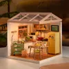 A miniature dollhouse kitchen scene with a greenhouse-style roof. Podgląd zdjęcia produktu