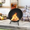 A fire pit with a fire burning on a wooden deck in front of a camper. Produktbild-Vorschau