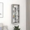 A gray wooden wall shelf with multiple compartments, decorated with various items, mounted on a white wall next to a curtain. Produktbild-Vorschau