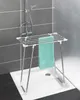 A drying rack with a teal towel is placed in a shower stall. Náhled obrázku produktu