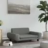 A dark gray pet sofa with a white pet bowl in front of it, next to a potted plant and a woven basket. Náhľad obrázku produktu