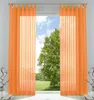 Two orange sheer curtains hang in front of a window with a view of a tree and sky. Produktbild-Vorschau