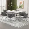 A dining room set with a white table and six gray chairs. Produktbild-Vorschau