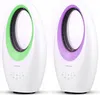 Two white bladeless fans, one with a green inner ring and the other with a purple inner ring, displayed side-by-side against a white background. Produktbild-Vorschau