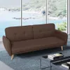 A brown sofa is placed in a room with a large window overlooking a body of water and hills. Anteprima dell’immagine prodotto