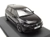 A black Volkswagen Golf VIII R model car is displayed on a dark gray base against a white background. Produktbild-Vorschau