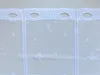 A close-up view of a white lace curtain with oval eyelets at the top and a snowflake pattern. Produktbild-Vorschau