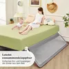 A mother and baby are on a bed with a bed rail in the foreground. Voir les images du produit