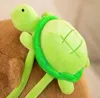 A close-up view of a plush toy turtle attached to the back of a brown capybara plush toy. Produktbild-Vorschau