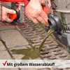 A person is using a wet/dry vacuum cleaner to drain dirty water into a drain on a paved surface. Produktbild-Vorschau
