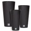 Three dark brown rattan-style planters of varying heights are arranged diagonally on a white background. Produktbild-Vorschau