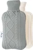 A gray knitted hot water bottle with a cream-colored rubber hot water bottle behind it. Produktbild-Vorschau