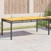 An outdoor patio table with a wooden top and a black metal frame, set on a paved patio with a wooden fence and greenery in the background. Produktbild-Vorschau