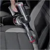 A person is using a cordless vacuum cleaner to clean car seats. Produktbild-Vorschau