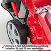 Close-up of a red lawnmower with a hand in a glove adjusting the cutting height. Produktbild-Vorschau