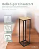 A tall, slender decorative stand with a wooden top and black metal frame, placed on a wooden floor. Text overlays suggest its use for plants, photos, and books. Produktbild-Vorschau