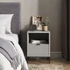 A bedside table next to a bed in a bedroom setting. Náhled obrázku produktu
