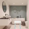 A modern bathroom with a bathtub, sink, and a shower stool. Voir les images du produit