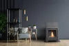 A cozy living room scene with a bioethanol fireplace, armchair, and shelving unit. Náhled obrázku produktu