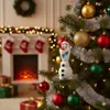A Christmas tree decorated with ornaments and tinsel, with a fireplace and stockings in the background. Produktbild-Vorschau