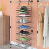 A hanging closet organizer filled with clothes and shoes, next to a dresser and a closet with dresses. Anteprima dell’immagine prodotto