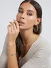 A close-up shot of a woman wearing jewelry. Podgląd zdjęcia produktu