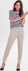 A woman posing in a studio setting wearing a striped t-shirt and beige pants. Produktbild-Vorschau