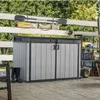 An outdoor storage cabinet is shown on a wooden deck, with a fence and greenery in the background. Anteprima dell’immagine prodotto